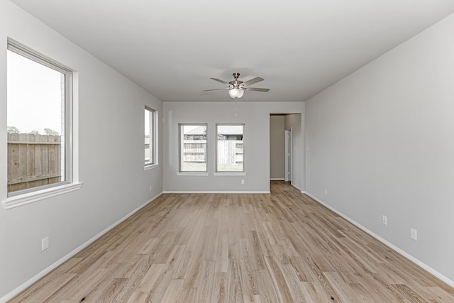 19253 Hazel Firs Ct, Magnolia, TX 77355 - unfurnished room featuring light wood finished floors, a ceiling fan, and baseboards
