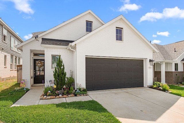 19253 Hazel Firs Ct, Magnolia, TX 77355 - view of front of house with brick siding, driveway, roof with shingles, and a front yard