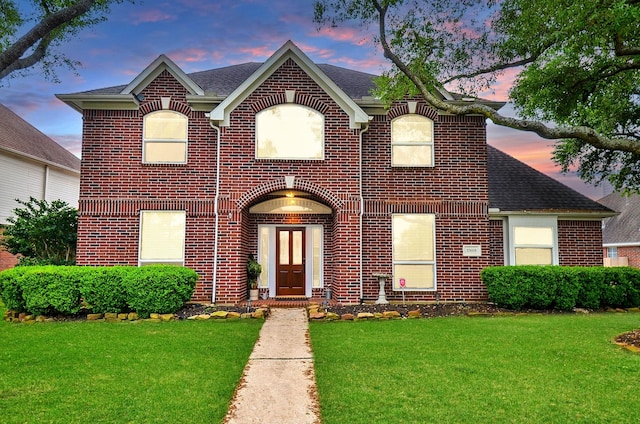 17619 Rustling Aspen Ln, Houston, TX 77095 - view of front facade featuring brick siding, a lawn, and a shingled roof