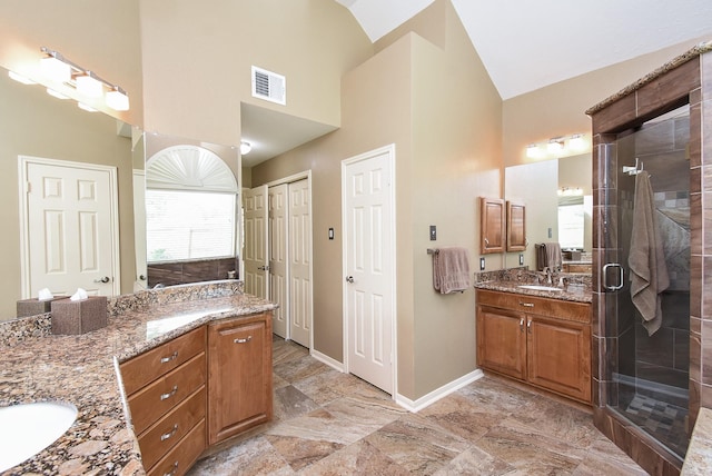 17619 Rustling Aspen Ln, Houston, TX 77095 - full bathroom with two vanities, high vaulted ceiling, and a shower stall