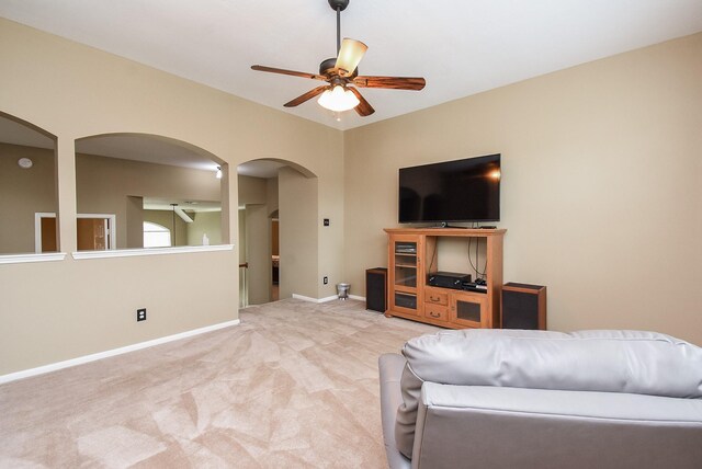 17619 Rustling Aspen Ln, Houston, TX 77095 - living area with arched walkways, a ceiling fan, and carpet flooring
