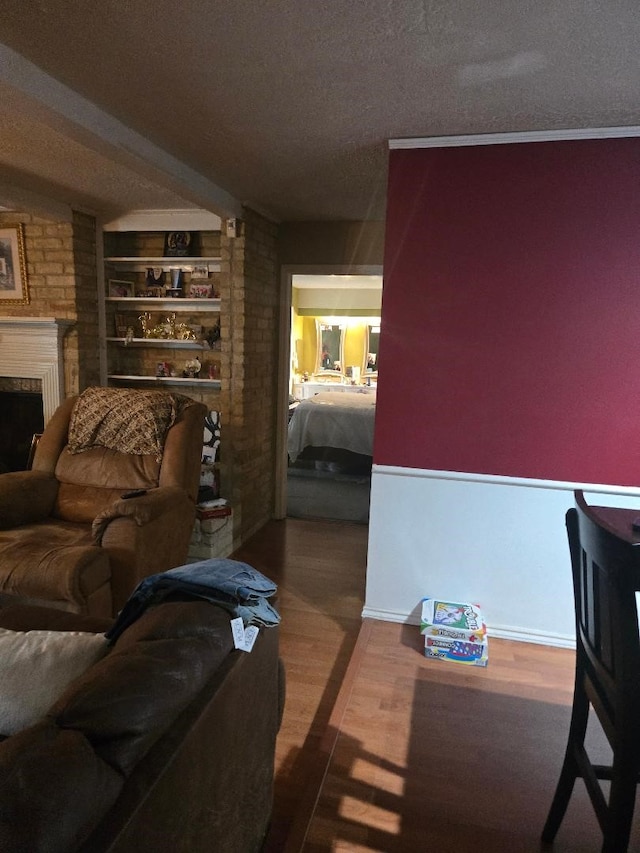 6815 Maczali Dr, Houston, TX 77489 - living area with a fireplace, wood finished floors, a textured ceiling, and built in features
