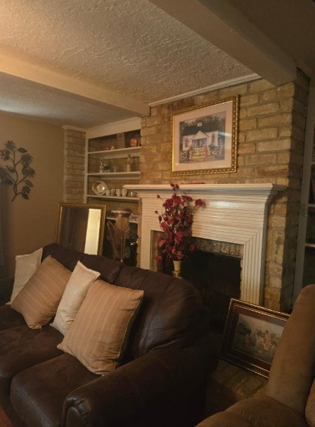 6815 Maczali Dr, Houston, TX 77489 - living room featuring a textured ceiling, a fireplace, built in shelves, and beam ceiling