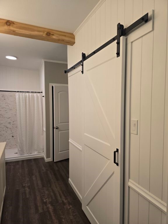 334 Wilcrest Dr Unit 334, Houston, TX 77042 - corridor with a barn door, dark wood finished floors, and crown molding