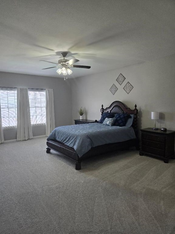 334 Wilcrest Dr Unit 334, Houston, TX 77042 - carpeted bedroom with ceiling fan and a textured ceiling