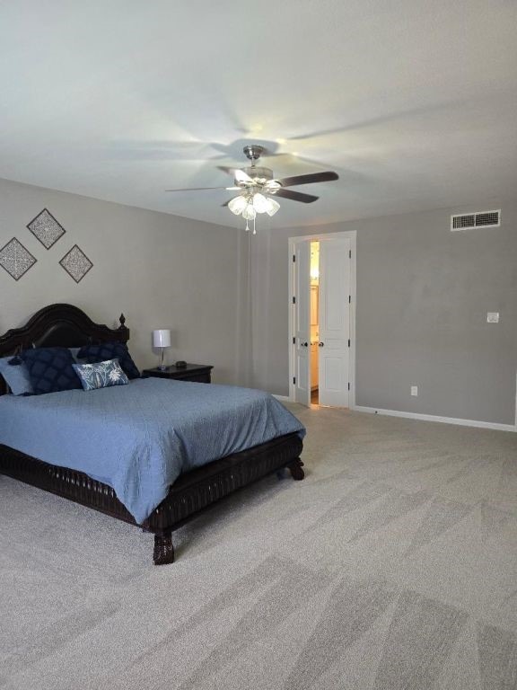 334 Wilcrest Dr Unit 334, Houston, TX 77042 - carpeted bedroom featuring baseboards and ceiling fan