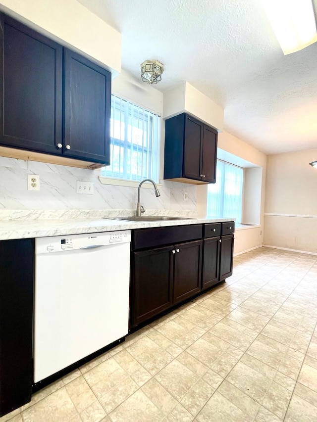 13011 Harwin Dr, Houston, TX 77072 - kitchen with dishwasher, light countertops, backsplash, a sink, and a textured ceiling