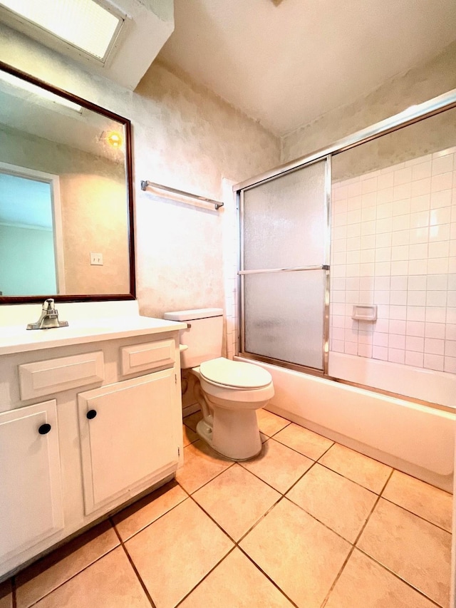 13011 Harwin Dr, Houston, TX 77072 - bathroom featuring vanity, toilet, tile patterned flooring, and combined bath / shower with glass door