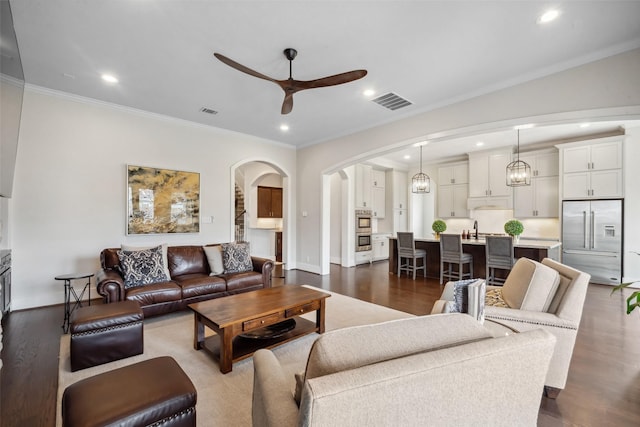 1746 Du Barry Ln, Houston, TX 77018 - living area featuring ceiling fan, arched walkways, ornamental molding, recessed lighting, and dark wood-type flooring