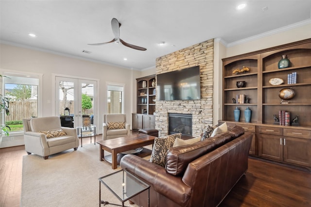 1746 Du Barry Ln, Houston, TX 77018 - living area featuring ceiling fan, ornamental molding, dark wood finished floors, a stone fireplace, and recessed lighting