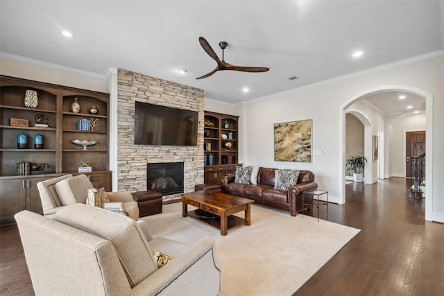 1746 Du Barry Ln, Houston, TX 77018 - living area with ceiling fan, arched walkways, recessed lighting, dark wood-type flooring, and a stone fireplace