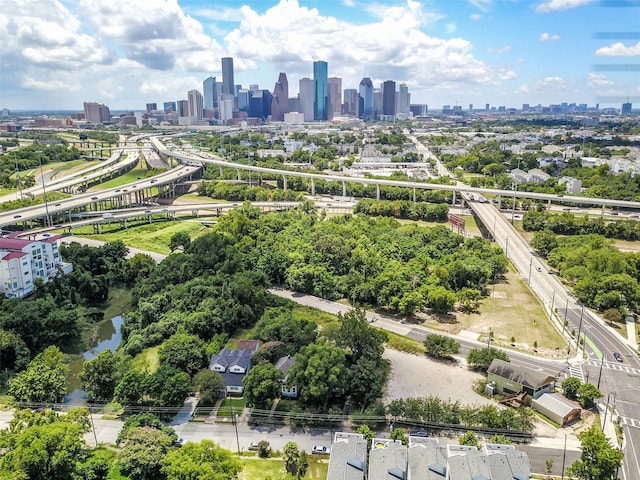 1746 Du Barry Ln, Houston, TX 77018 - drone / aerial view of city skyline, a main thoroughfare, and a tree filled landscape