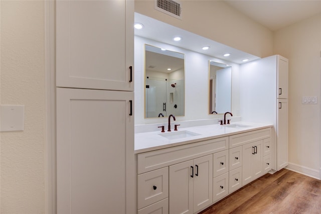 16727 Camber Ct, Crosby, TX 77532 - bathroom featuring double vanity, a shower stall, wood finished floors, recessed lighting, and baseboards