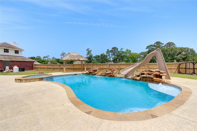 16727 Camber Ct, Crosby, TX 77532 - view of pool with a gazebo, a fenced backyard, a water slide, a pool with connected hot tub, and a patio area