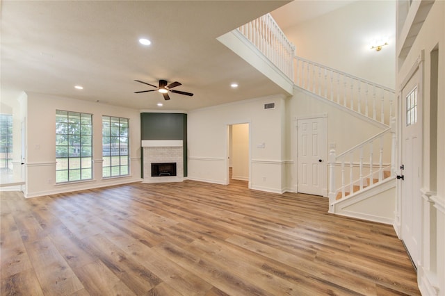 16727 Camber Ct, Crosby, TX 77532 - unfurnished living room featuring stairs, light wood-style flooring, recessed lighting, a ceiling fan, and ornamental molding