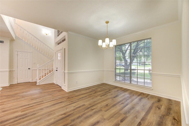 16727 Camber Ct, Crosby, TX 77532 - spare room featuring a chandelier, wood finished floors, stairway, ornamental molding, and baseboards