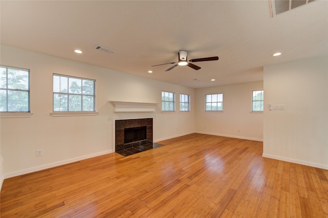 16727 Camber Ct, Crosby, TX 77532 - unfurnished living room with ceiling fan, light wood-style floors, recessed lighting, a tiled fireplace, and baseboards