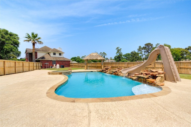 16727 Camber Ct, Crosby, TX 77532 - view of pool featuring a water slide, a gazebo, a fenced backyard, a patio, and a pool with connected hot tub
