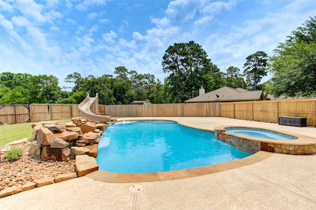 16727 Camber Ct, Crosby, TX 77532 - view of swimming pool with a water slide, a fenced backyard, a pool with connected hot tub, and a patio
