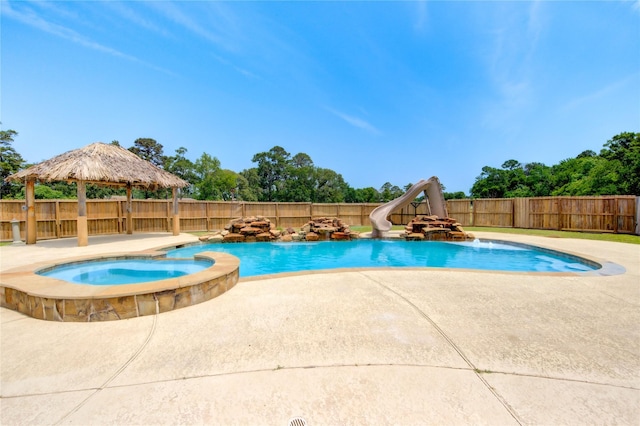 16727 Camber Ct, Crosby, TX 77532 - view of swimming pool with a water slide, a gazebo, a patio area, a fenced backyard, and a pool with connected hot tub