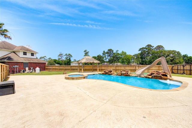 16727 Camber Ct, Crosby, TX 77532 - view of pool with a water slide, a fenced backyard, a patio, and a pool with connected hot tub