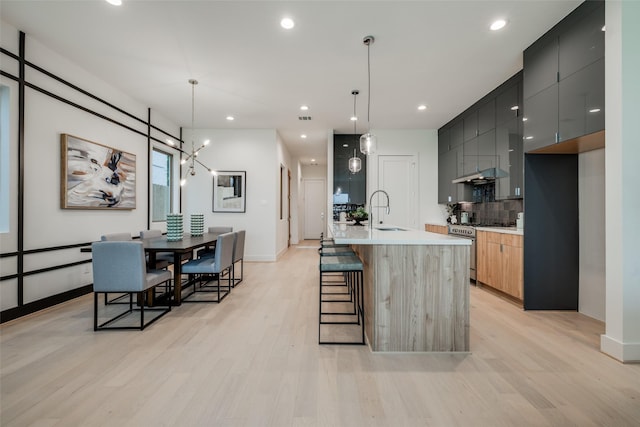 1851 Sul Ross St, Houston, TX 77098 - kitchen with stainless steel range with gas cooktop, modern cabinets, under cabinet range hood, a sink, and recessed lighting