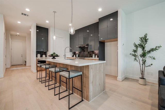 1851 Sul Ross St, Houston, TX 77098 - kitchen featuring modern cabinets, tasteful backsplash, light wood-style floors, a sink, and recessed lighting