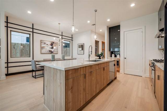1851 Sul Ross St, Houston, TX 77098 - kitchen featuring a sink, modern cabinets, stainless steel dishwasher, light wood-style flooring, and gas range