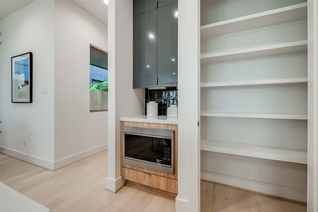 1851 Sul Ross St, Houston, TX 77098 - bar area featuring stainless steel microwave, light wood finished floors, and baseboards