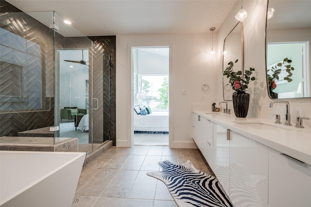 1851 Sul Ross St, Houston, TX 77098 - full bathroom featuring a soaking tub, double vanity, a shower stall, tile patterned flooring, and recessed lighting