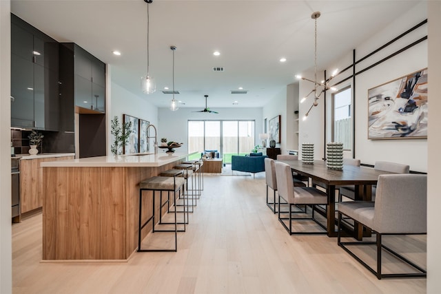 1851 Sul Ross St, Houston, TX 77098 - kitchen featuring modern cabinets, light wood-style floors, light countertops, open floor plan, and recessed lighting