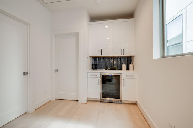1851 Sul Ross St, Houston, TX 77098 - indoor dry bar with beverage cooler, light wood-type flooring, and decorative backsplash