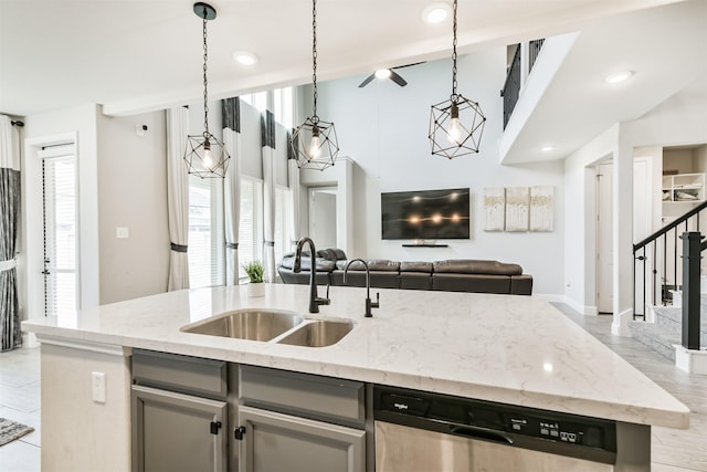 19303 Belmont Stakes Way, Tomball, TX 77377 - kitchen with a sink, stainless steel dishwasher, open floor plan, a center island with sink, and light stone counters