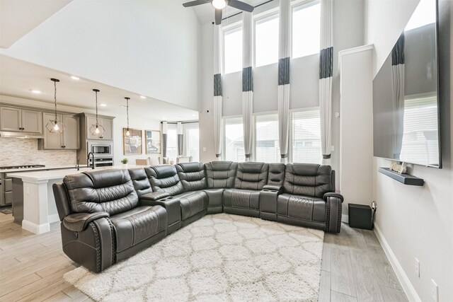 19303 Belmont Stakes Way, Tomball, TX 77377 - living area with a ceiling fan, a high ceiling, light wood-style floors, and healthy amount of natural light