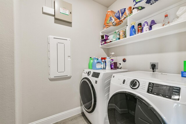 19303 Belmont Stakes Way, Tomball, TX 77377 - laundry area with washer and clothes dryer, baseboards, and wood finished floors