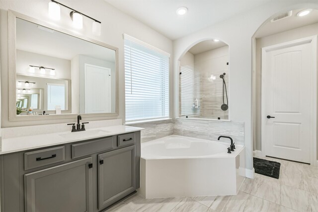 19303 Belmont Stakes Way, Tomball, TX 77377 - full bathroom with a garden tub, vanity, and a shower
