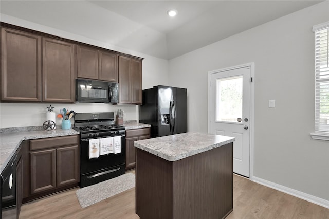 13999 Katlin Rd, Conroe, TX 77306 - kitchen featuring black appliances, light wood-type flooring, dark brown cabinetry, light countertops, and lofted ceiling