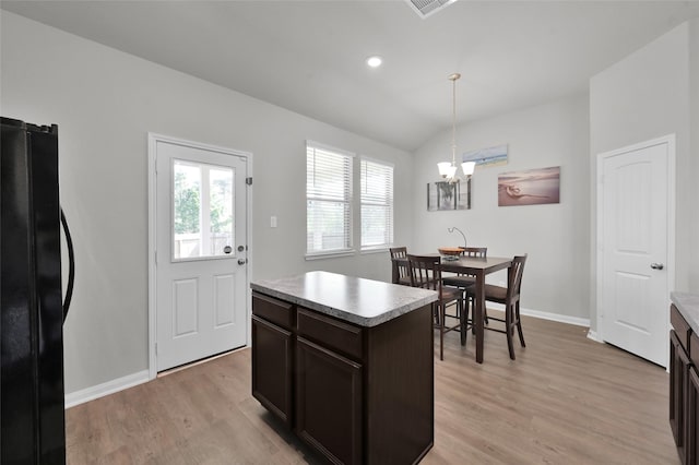 13999 Katlin Rd, Conroe, TX 77306 - kitchen with freestanding refrigerator, a chandelier, light wood finished floors, baseboards, and lofted ceiling