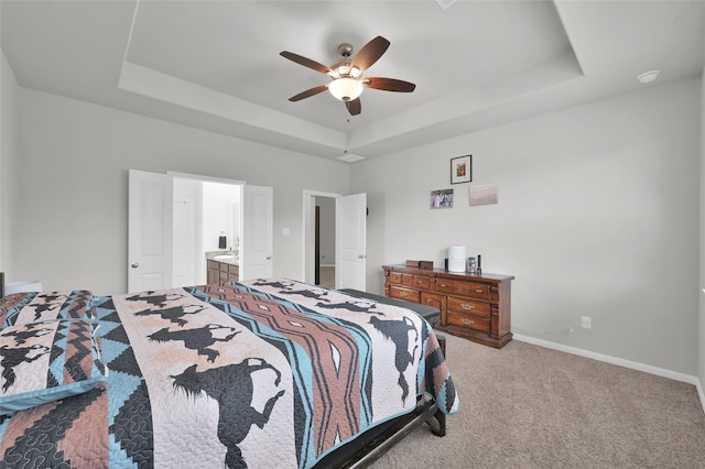 13999 Katlin Rd, Conroe, TX 77306 - bedroom with a raised ceiling, carpet flooring, baseboards, ceiling fan, and ensuite bath