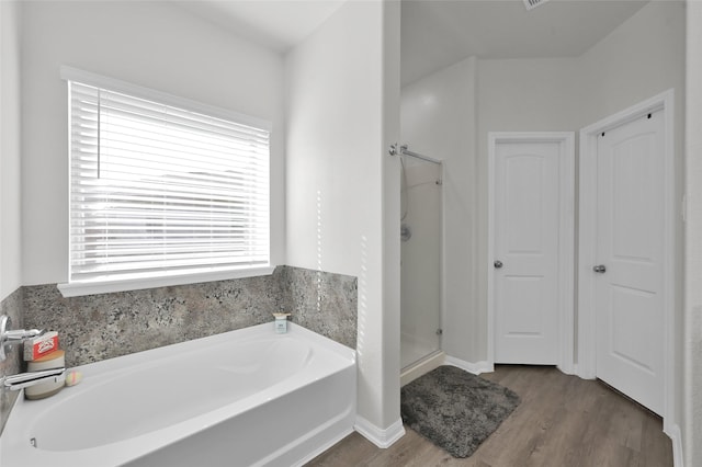 13999 Katlin Rd, Conroe, TX 77306 - bathroom featuring a garden tub, a shower stall, and wood finished floors