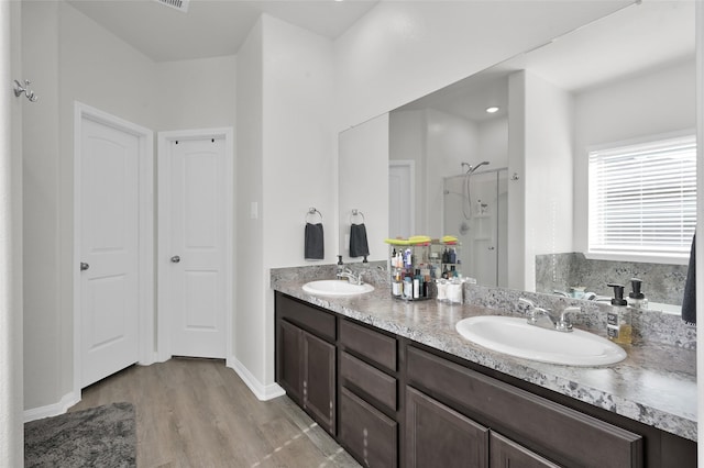 13999 Katlin Rd, Conroe, TX 77306 - full bath with a stall shower, wood finished floors, and double vanity