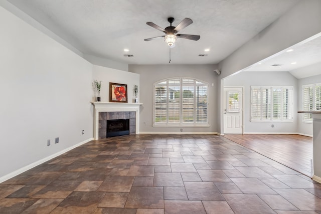 9515 Willow Crossing Dr, Houston, TX 77064 - unfurnished living room featuring a tiled fireplace, baseboards, a ceiling fan, and recessed lighting
