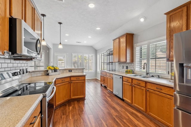 9515 Willow Crossing Dr, Houston, TX 77064 - kitchen featuring appliances with stainless steel finishes, a sink, plenty of natural light, light countertops, and recessed lighting