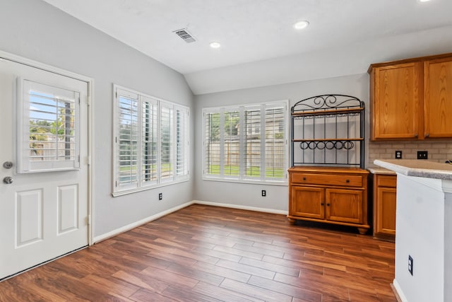 9515 Willow Crossing Dr, Houston, TX 77064 - kitchen featuring plenty of natural light, vaulted ceiling, dark wood-style flooring, brown cabinets, and baseboards