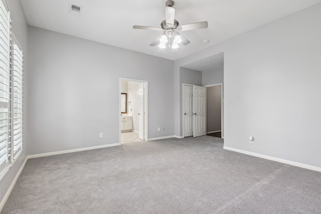 9515 Willow Crossing Dr, Houston, TX 77064 - unfurnished bedroom with carpet floors, multiple windows, baseboards, and ensuite bathroom