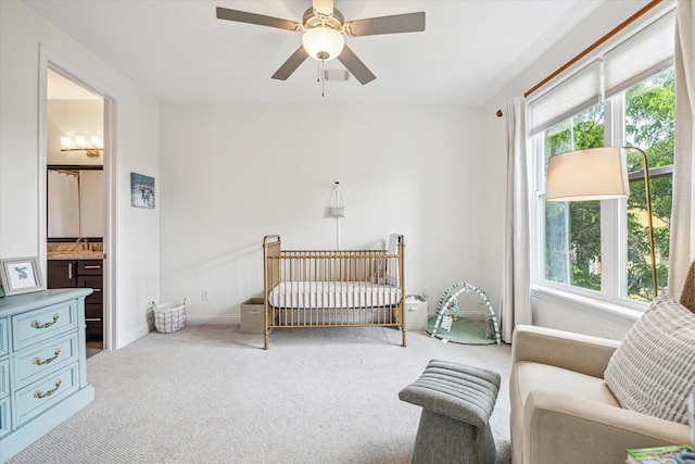 6123 Stillman St, Houston, TX 77007 - carpeted bedroom featuring multiple windows, baseboards, a nursery area, and a ceiling fan