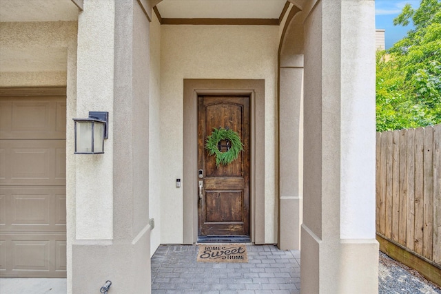 6123 Stillman St, Houston, TX 77007 - view of exterior entry featuring stucco siding and a garage