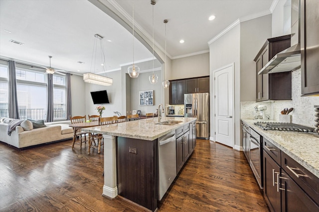 6123 Stillman St, Houston, TX 77007 - kitchen with stainless steel appliances, open floor plan, dark brown cabinets, ornamental molding, and a sink