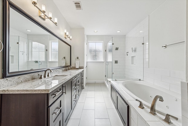 6123 Stillman St, Houston, TX 77007 - bathroom featuring double vanity, a jetted tub, a shower stall, tile patterned flooring, and baseboards