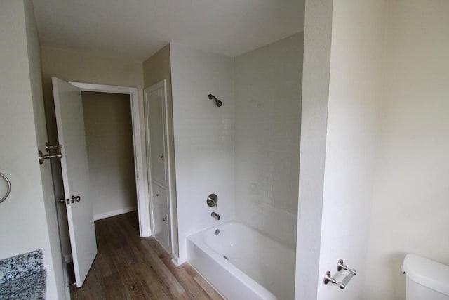 1215 Maplewood Ln, Pasadena, TX 77502 - bathroom featuring wood finished floors, tub / shower combination, and toilet